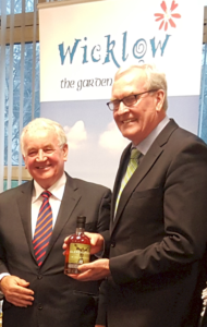 Ambassador Kevin Vickers with a bottle of Glendalough Whiskey